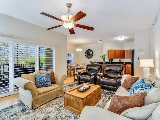 living room with light hardwood / wood-style flooring and ceiling fan