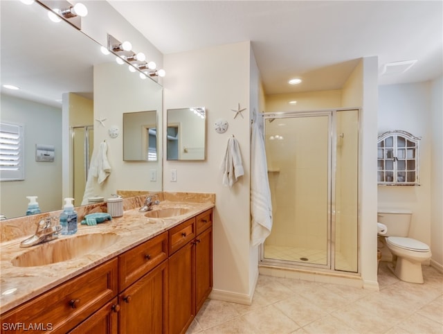 bathroom featuring tile floors, toilet, double vanity, and walk in shower