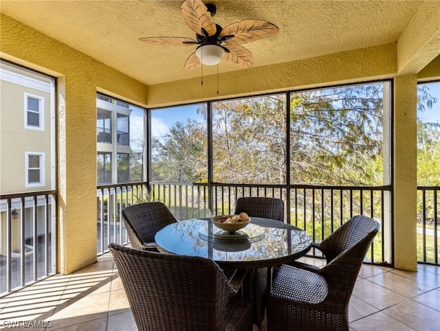 sunroom with plenty of natural light and ceiling fan