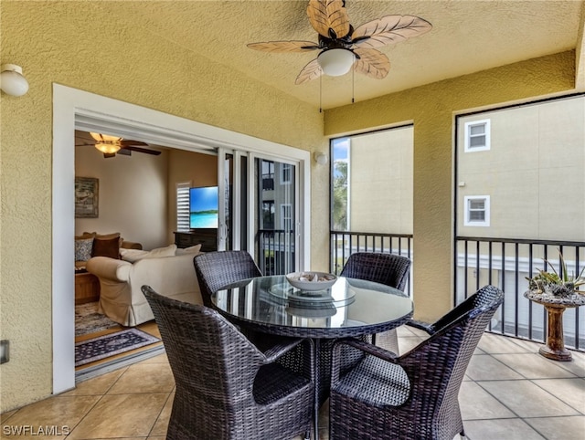 dining room featuring light tile floors, plenty of natural light, and ceiling fan