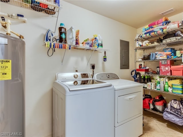 clothes washing area with electric dryer hookup, electric water heater, independent washer and dryer, and light tile floors