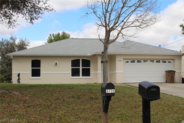 view of front of home featuring a front lawn and a garage