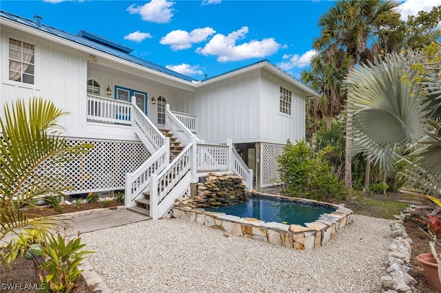 view of pool featuring covered porch