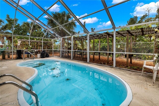 view of pool with a patio area and a lanai