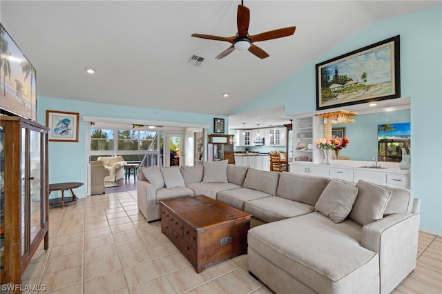 tiled living room with lofted ceiling and ceiling fan