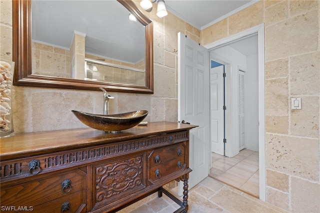 bathroom with crown molding and vanity