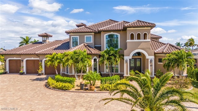 mediterranean / spanish house featuring a garage