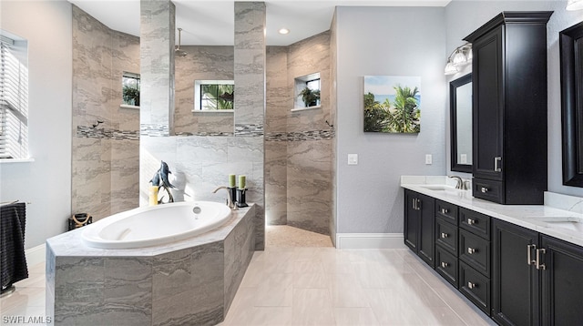 bathroom with tile floors, dual vanity, and independent shower and bath