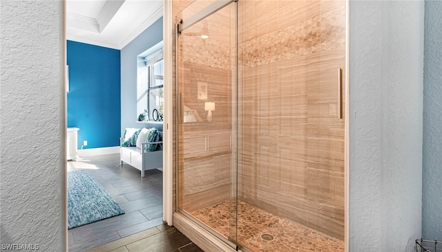 bathroom with a shower with door, tile flooring, and ornamental molding