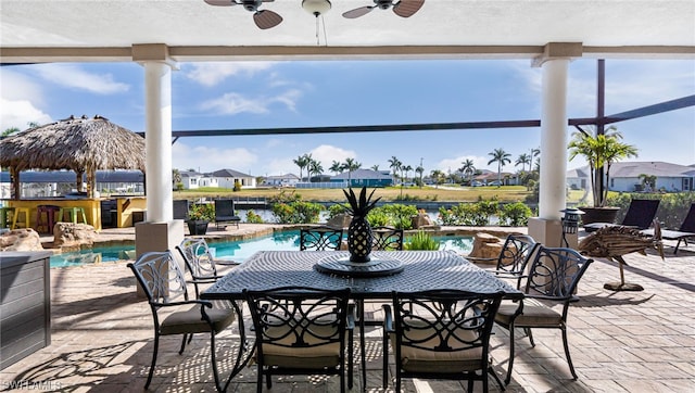 sunroom featuring ceiling fan