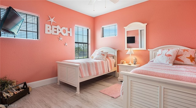 bedroom with ceiling fan and light hardwood / wood-style flooring