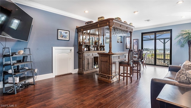 bar featuring ornamental molding and dark wood-type flooring