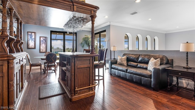 living room featuring crown molding, dark hardwood / wood-style floors, and a notable chandelier