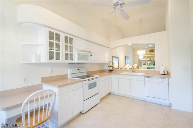 kitchen featuring white appliances, ceiling fan, white cabinets, light tile flooring, and high vaulted ceiling