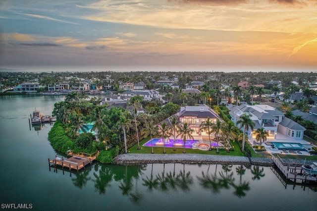 aerial view at dusk with a water view