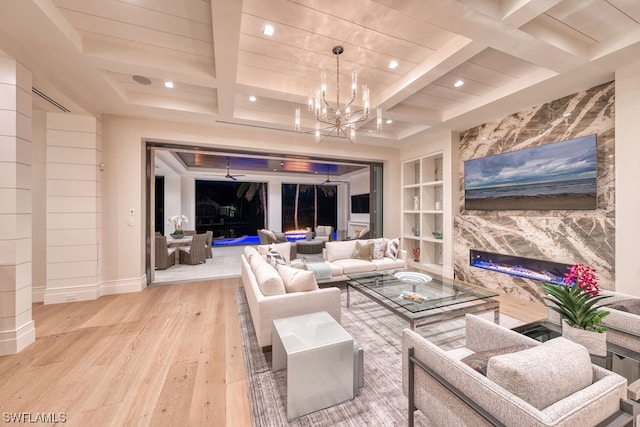 living room with a chandelier, coffered ceiling, beamed ceiling, light hardwood / wood-style flooring, and built in shelves