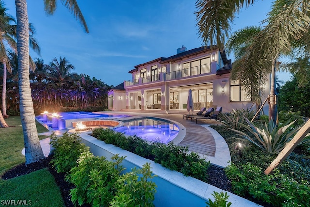 view of swimming pool featuring an in ground hot tub and a patio area