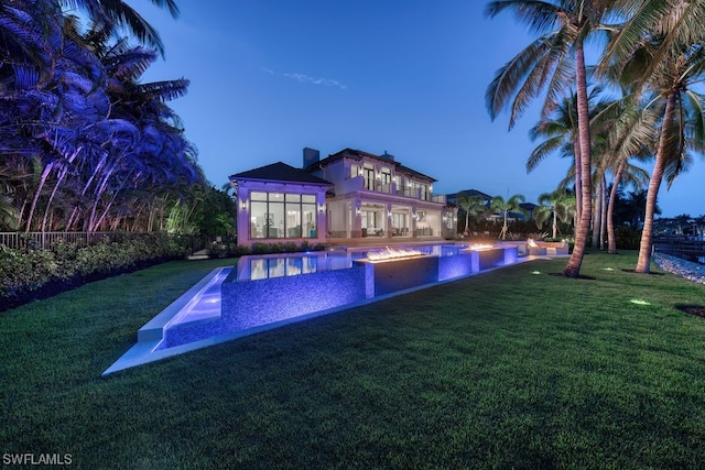 view of swimming pool with a yard