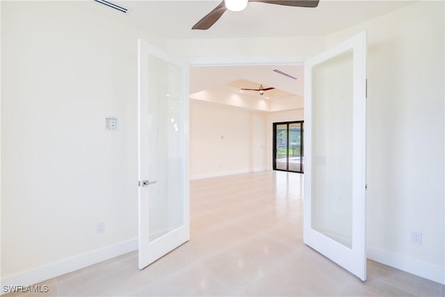 unfurnished room featuring french doors, ceiling fan, and a tray ceiling