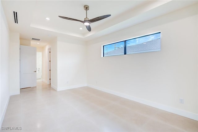 unfurnished room with a tray ceiling and ceiling fan