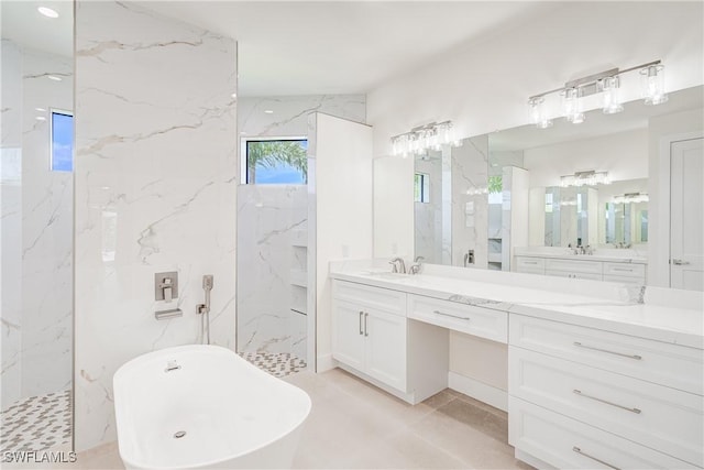 bathroom with a freestanding bath, vanity, and a marble finish shower