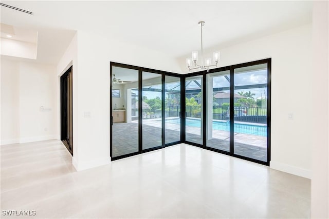 unfurnished room with an inviting chandelier