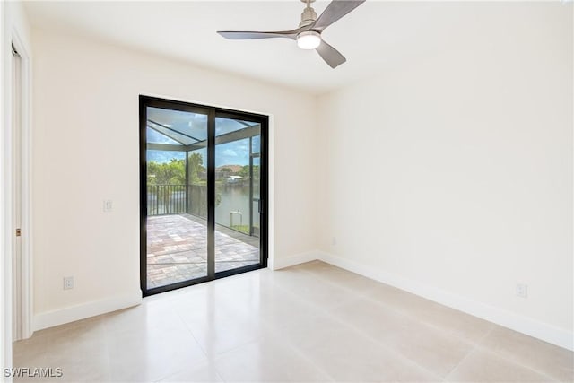 spare room featuring light tile patterned floors and ceiling fan