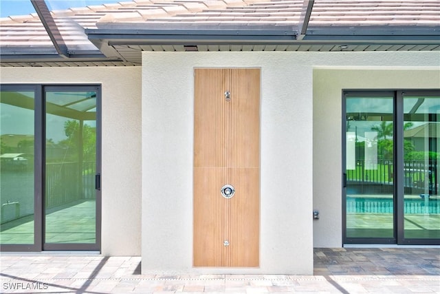 property entrance with stucco siding