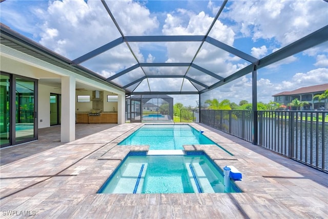 view of swimming pool with an in ground hot tub, a lanai, and a patio