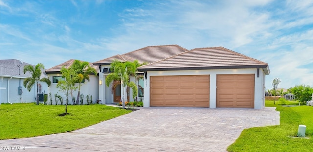 view of front of home featuring a garage, a front lawn, and central air condition unit