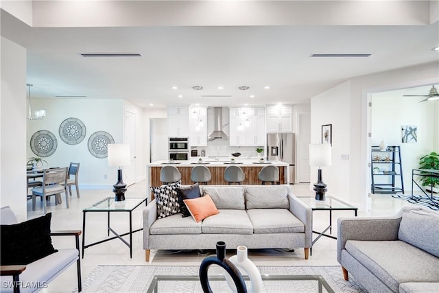 living room with recessed lighting, baseboards, and an inviting chandelier