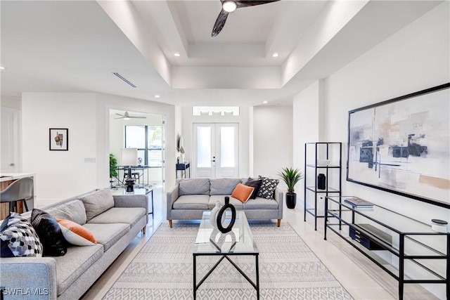 living room featuring visible vents, a ceiling fan, a tray ceiling, french doors, and recessed lighting