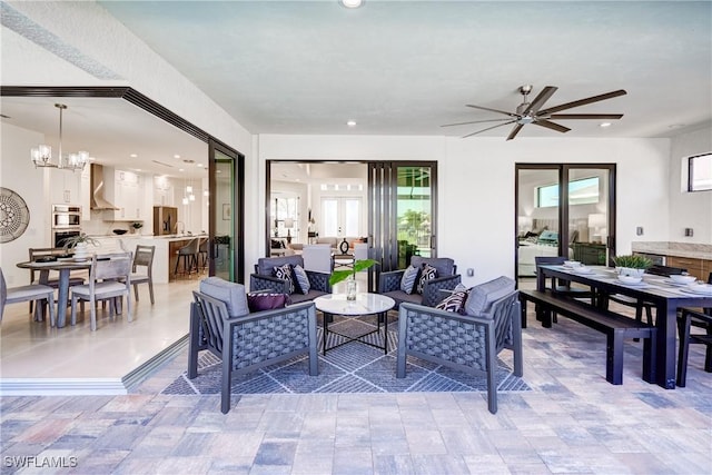 view of patio / terrace with outdoor dining space, an outdoor living space, and a ceiling fan