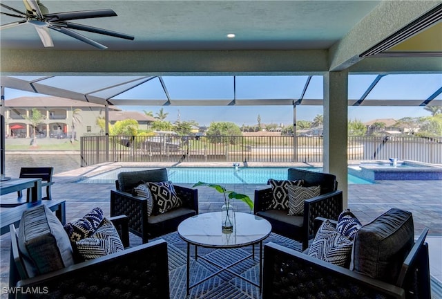 view of patio / terrace featuring ceiling fan, a lanai, an outdoor living space, and fence