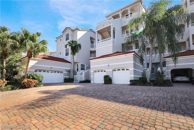 view of front of house featuring a balcony and a garage