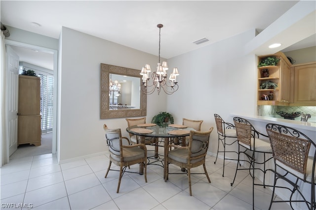 tiled dining space featuring a chandelier