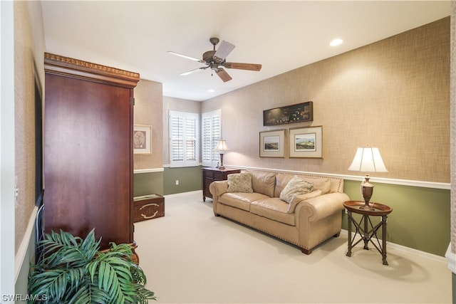 carpeted living room with ceiling fan