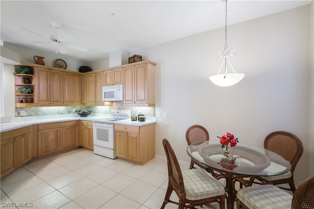 kitchen featuring backsplash, light tile patterned floors, hanging light fixtures, and white appliances