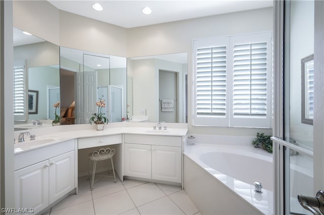 bathroom featuring tile patterned flooring, vanity, and shower with separate bathtub