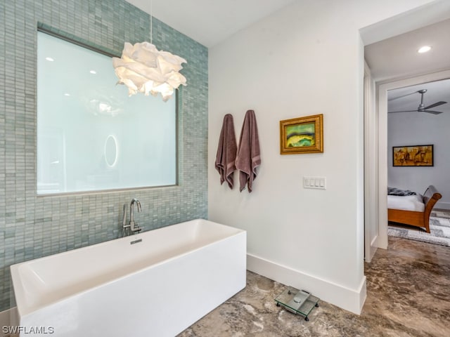 bathroom featuring ceiling fan, a bathing tub, and tile walls