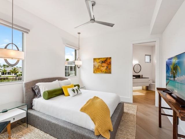 bedroom featuring ensuite bathroom, ceiling fan, and light hardwood / wood-style floors