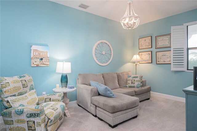 carpeted living room featuring a chandelier