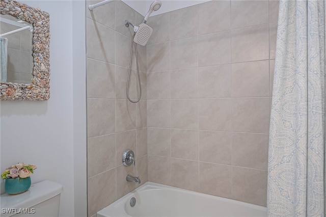 bathroom with shower / bath combination with curtain and toilet