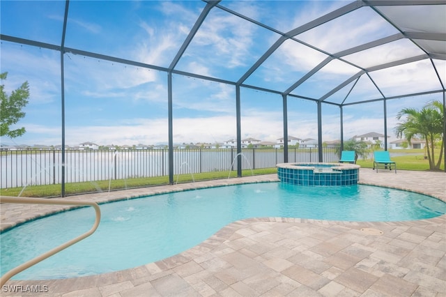 view of pool with a water view, glass enclosure, a patio area, and an in ground hot tub