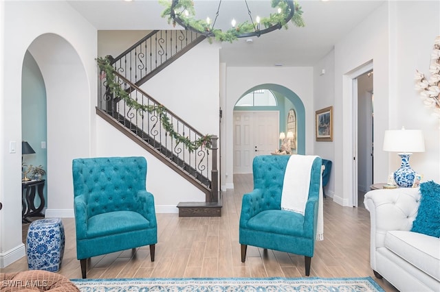 sitting room featuring hardwood / wood-style floors and a chandelier