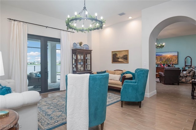 living room featuring a chandelier and light hardwood / wood-style flooring