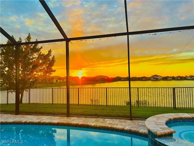 pool at dusk with a yard and a lanai