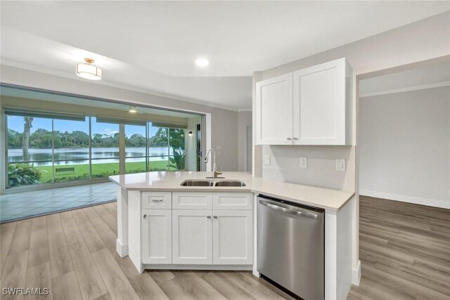 kitchen featuring ornamental molding, white cabinets, a sink, and stainless steel dishwasher