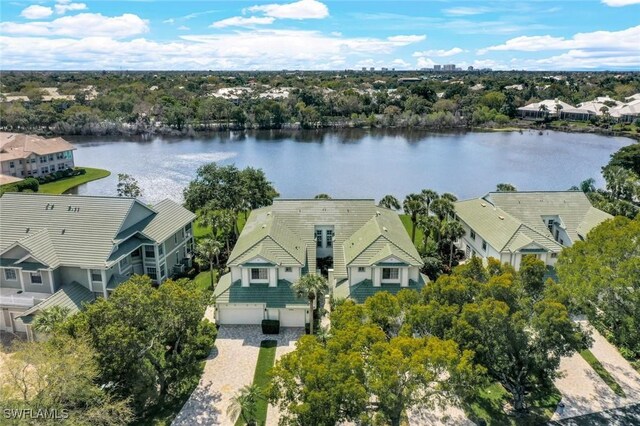 drone / aerial view with a water view and a residential view