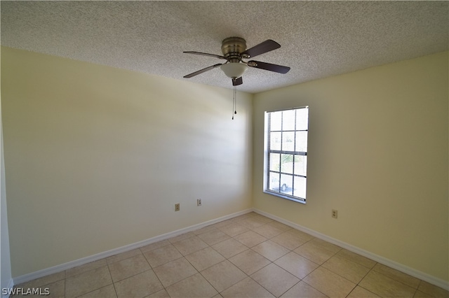 unfurnished room featuring ceiling fan, a textured ceiling, and light tile floors